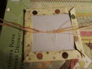 Tape the raffia into the middle of the inside back cover. (Step 8)