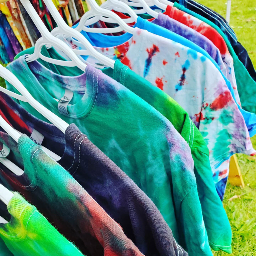 Photo of a rack of tie-dyed shirts