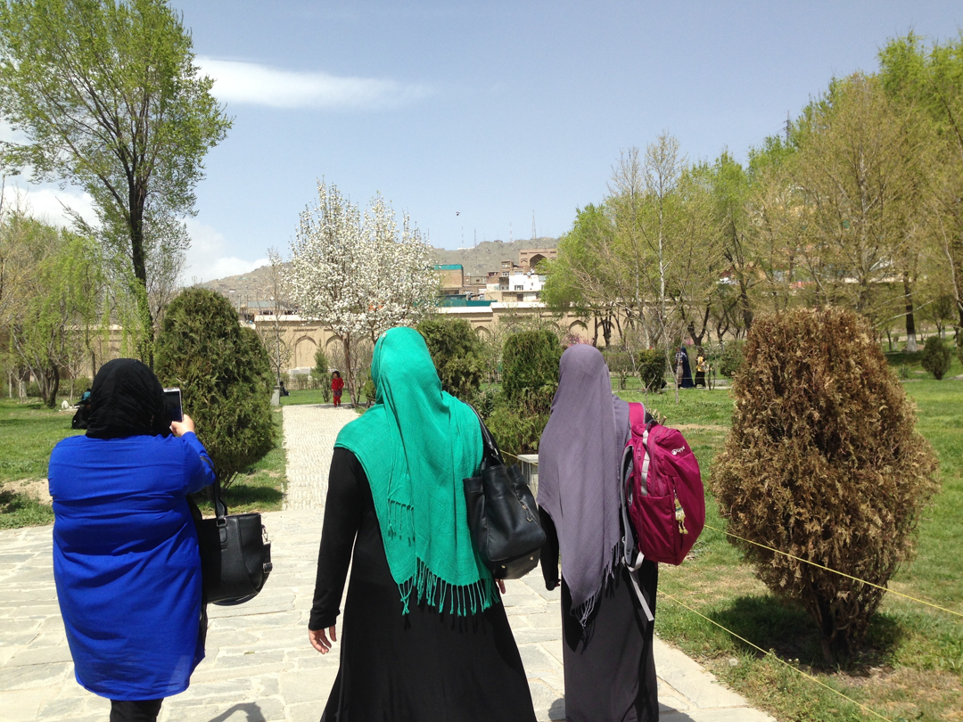 Photo of women walking down a garden path in Afghanistan
