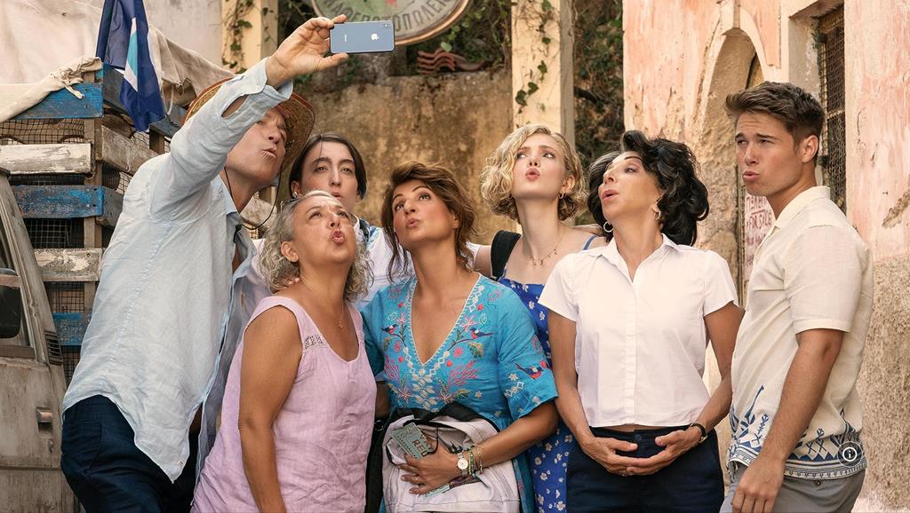 Various characters looking at a phone while one person holds the phone towards them and takes a selfie