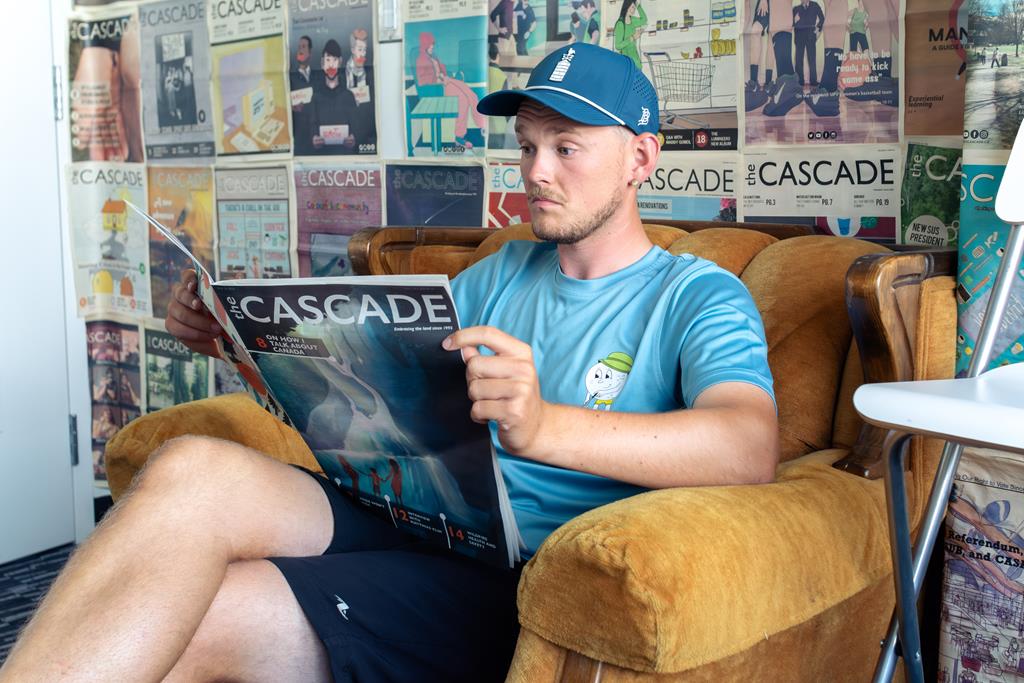 Eli Greene reading the latest issue of the Cascade