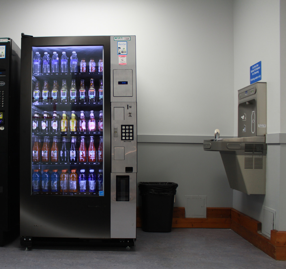 vending machine on the left with water fountain on the right.