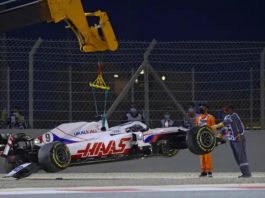 Photo of a Formula One car being lifted with a crane after a crash
