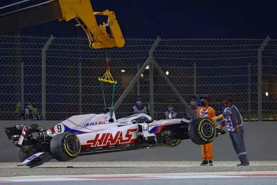 Photo of a Formula One car being lifted with a crane after a crash