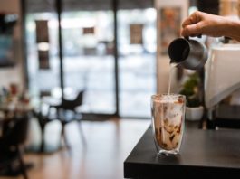 Photo of a barista pouring an iced coffee