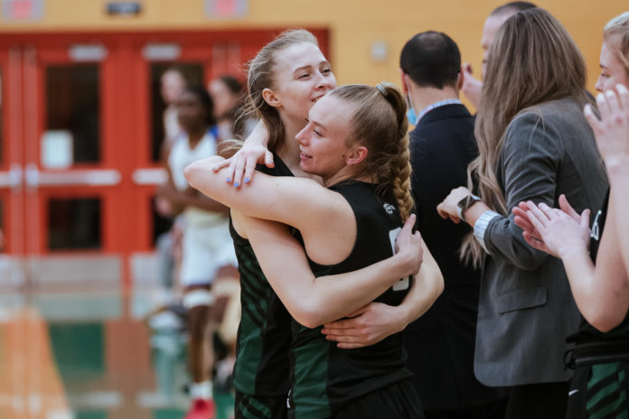 Photo of Women's basketball player Alexis Worrell hugging a teammate
