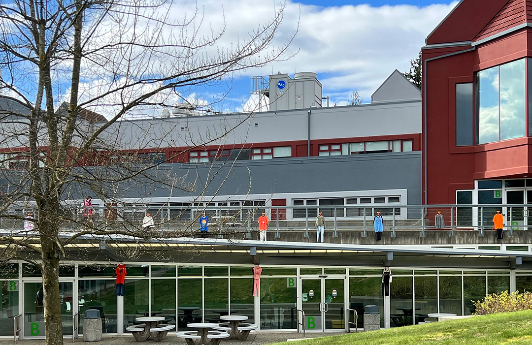 Photo of UFV Abbotsford's B Building with children's clothing hanging from the balconies