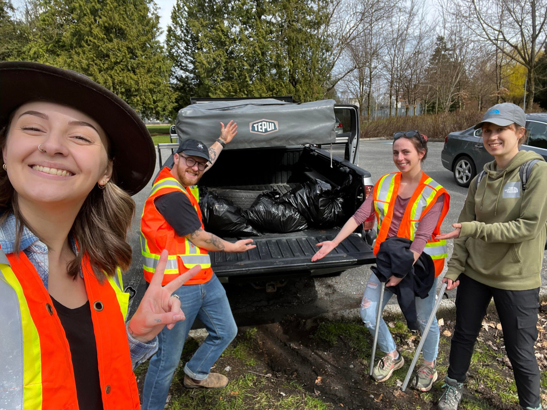 Photo of the UFV Wildlife Protection Club showing several full garbage bags in the back of a truck, wearing high visibility vests after their cleanup