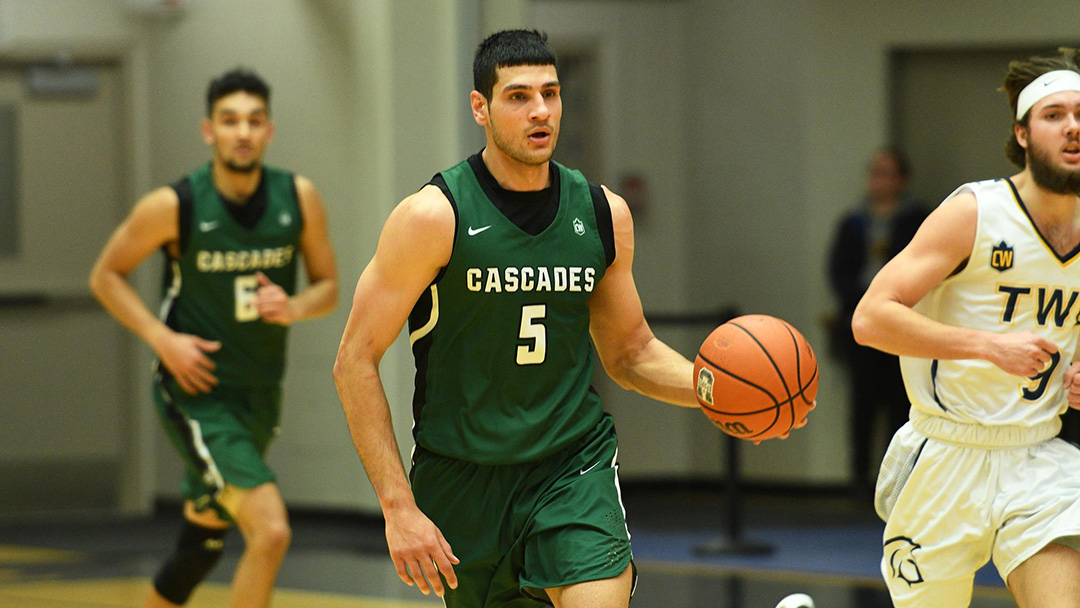 Photo of Sukhjot Bains in a UFV Cascades jersey playing basketball