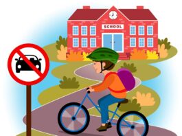 A boy with a backpack riding his bike to the school on a windy road. There is a road sign in the foreground of the illustration showing that cars are prohibited. There is a school building in the background.