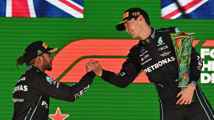 George Russell stands on top of the Brazil Grand Prix podium as a first time Formula One race winner
