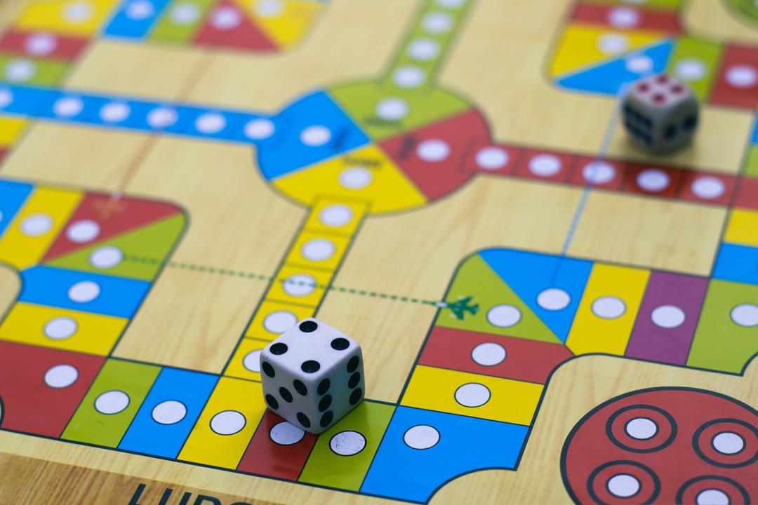 Photo of a board game board with dice sitting on it.