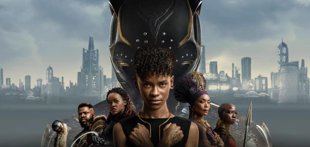 The cast of Black Panter standing in front of the Black Panther Mask. The characters all have thier hands crossed on their chest.