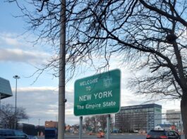 A green sign saying "welcome to New York, the empire state."