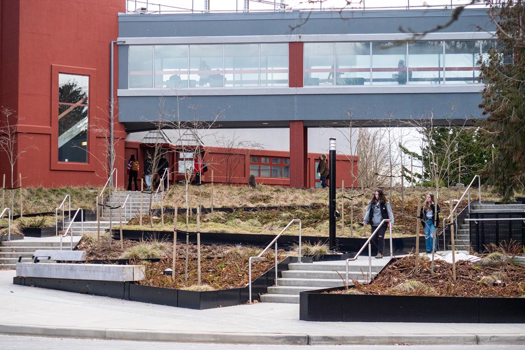 A spring scene on the UFV Abbotsford Campus. Showing the stairs outside the B building. A few students make their way to class.