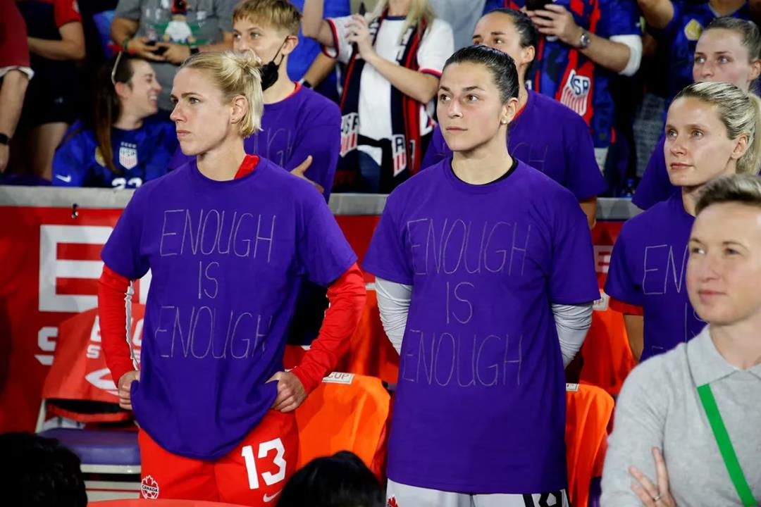 Sophie Schmidt and Sabrina Dangelo stand in purple shirts with 