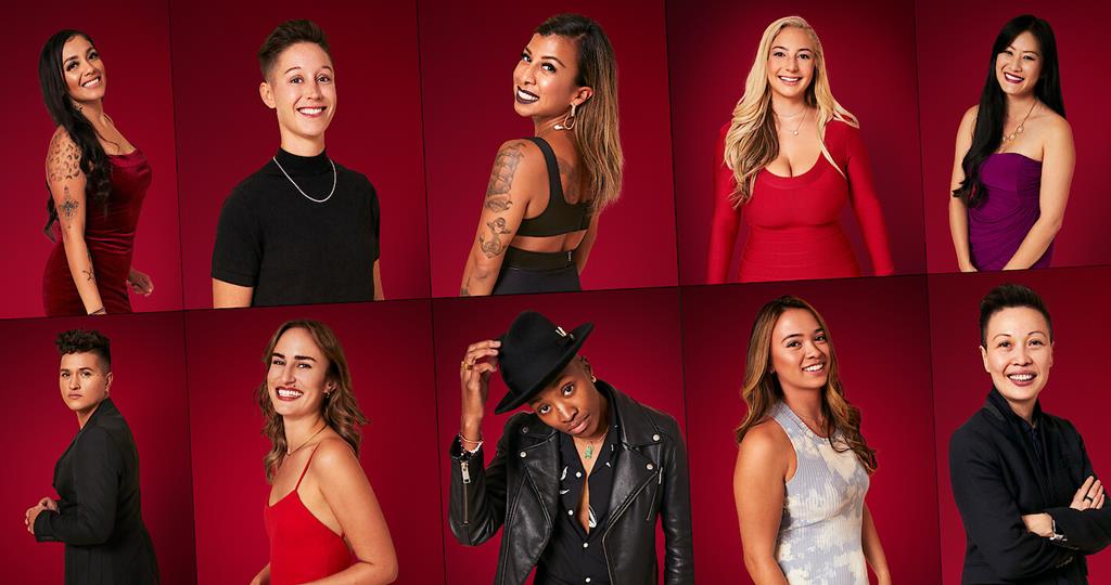 The cast of the show posing in front of a red background