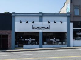 A photo of the storefront in downtown Abbotsford, the sign reads "Boardwalk Games Cafe"
