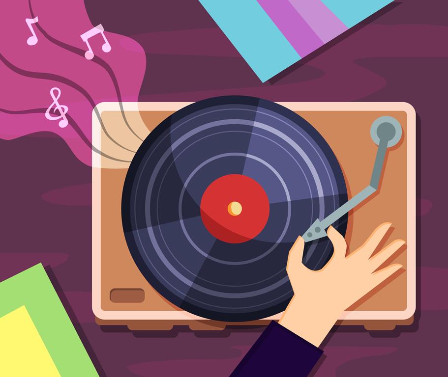 A hand placing a record player needle onto a record player