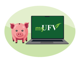 A piggy bank sitting next to a laptop with the screen displaying the myUFV logo