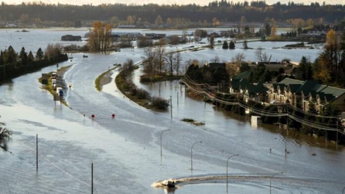 A boat speeds along a flooded highway 1 in Abbotsford, B.C., Tuesday, Nov. 16, 2021.